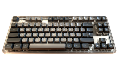 Clear acrylic case encloses a mechanical keyboard with dark gray keys
