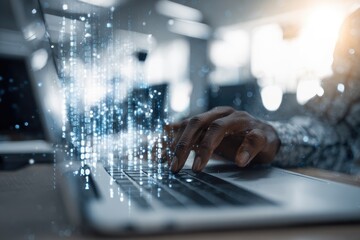 Close-up of hands typing on a laptop, overlaid with digital binary code