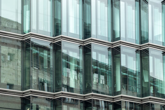 Modern business building with repetitive glass facade and cube like structures, architectural exterior detail reflecting contemporary urban identity, rhythm and precision in design