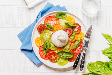 Fresh burrata served on slices of colorful tomatoes
