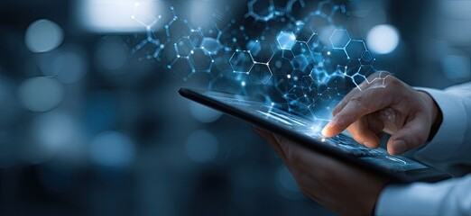 A hand interacts with a tablet displaying abstract, glowing, molecular structures