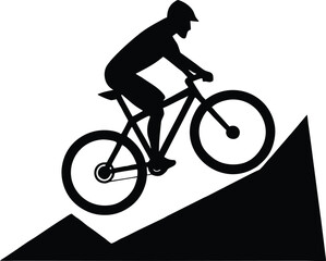 Obraz premium Silhouette of a mountain biker riding downhill on a steep slope
