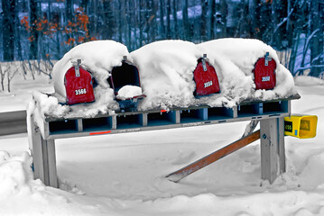 Mailboxes are covered with white snow after winter storm
