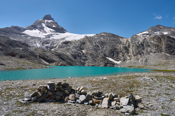 Small lake Goletta beneath the peak of Granta Parey in the Graian Alps in Italy. A glacial lake of...
