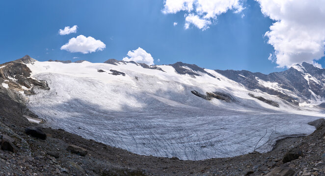Mountain landscape with crevassed Glairetta glacier in the Graian Alps in Italy. Hiking trail from Benevolo refuge via the mountain pass Col Bassac Dere. Spectacular views along the glacier.