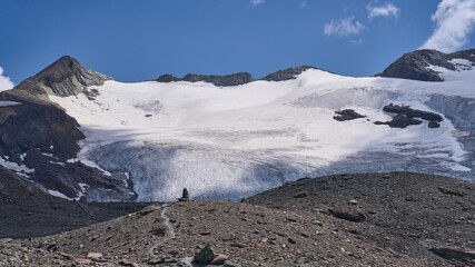 Mountain landscape with crevassed Glairetta glacier in the Graian Alps in Italy. Hiking trail from Benevolo refuge via the mountain pass Col Bassac Dere. Spectacular views along the glacier.