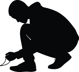 Silhouette of a person tying shoelaces