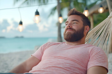 Relaxed man with beard lounging in a hammock by the beach, surrounded by tropical scenery and soft lighting, enjoying a peaceful moment in a glamping setting