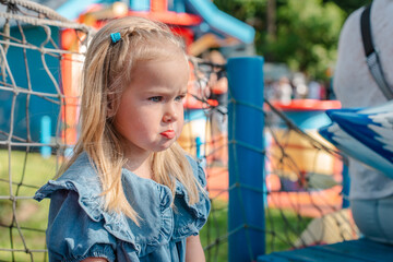 Cute little child girl frowned and pouted