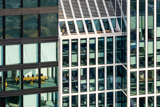 Glass office facade in Frankfurt financial district with geometric grid pattern, modern architecture detail reflecting corporate identity, innovation and progress in contemporary urban design