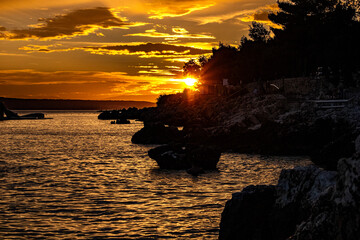 A scenic mountain landscape at sunrise with clouds in the sky