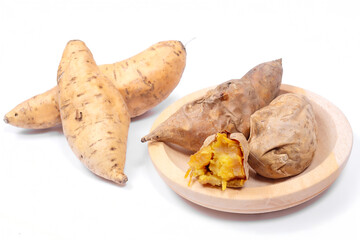 Cilembu sweet potatoes, raw and roasted on wooden plate, showing golden flesh texture, delicious organic root vegetable from Indonesia.