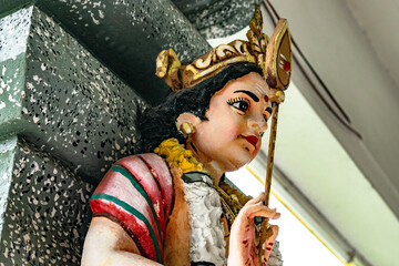 Colorful statue of hindu deity holding a stick in penang, malaysia