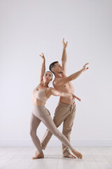 Couple of professional dancers training in studio