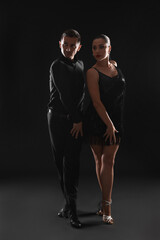 Couple of professional dancers on dark background