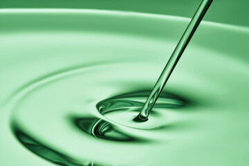 The oil flows and collects into a drop. The texture of the cosmetic product.