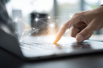 Close-up of a hand touching a laptop keyboard with a network graphic overlay