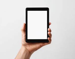 Hand holding a black tablet with a blank white screen against a light gray background