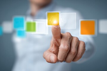 Close-up of a hand interacting with a glowing, translucent interface of colored squares