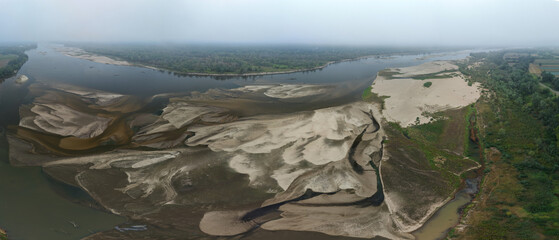 Aerial panoramic view of dried riverbed during record summer drought, historic low water level of the Vistula river in Poland.