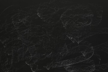 Chalk rubbed out on black chalkboard as background, closeup. Space for text