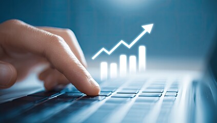 Close-up of hand on laptop keyboard with overlaying graph growth