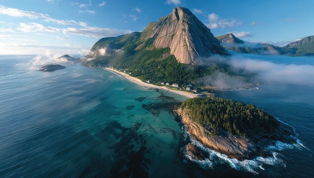 Aerial view of a fjord with mountains, mist, and coastline