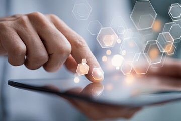 Close-up of hands interacting with a tablet, displaying abstract hexagonal shapes