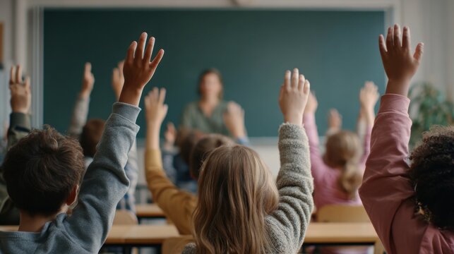 Children raising hands in class