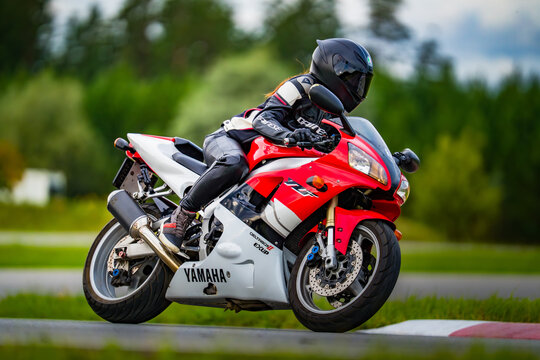 Latvia, Riga, 2025-08-27, regular trainingA rider in full gear commands a Yamaha motorcycle on a sunny race track