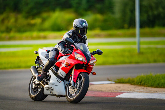 Latvia, Riga, 2025-08-27, regular trainingA rider in full gear commands a red and white Yamaha motorcycle