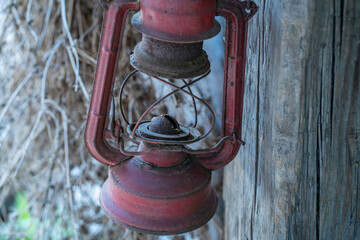 Close-Up of Rusty Red Lantern on Weathered Wood – Rural Vintage Detail