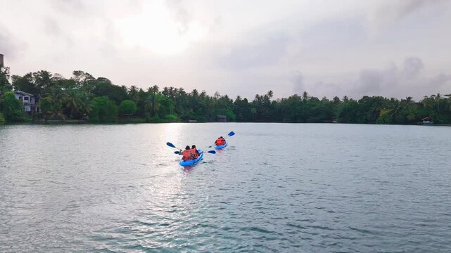 Evening Drone Push In Shot of 2 Kayakers Gliding Across a Reflective Lagoon Surface in Hikkaduwa 