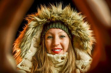 Smiling woman in winter clothes posing on Christmas night