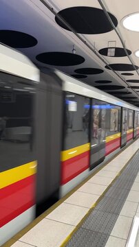 Modern metro arriving at an underground station: fast electric subway train, sustainable mobility for the urban commute. Safe platform with tactile paving, smart city design, public transport. Swift.