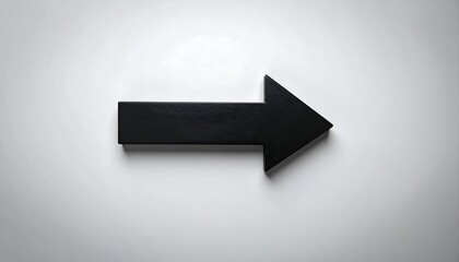 A simple black arrow against a bright white background.  A directional sign