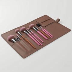 Set of Makeup Brushes in Brown Leather Roll on Clean White Background