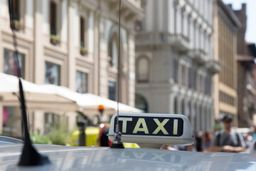 Checker taxi lighted rooftop car on a blurred background