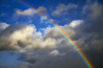 Rainbow, clouds and blue sky.