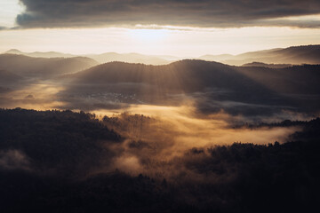 Sunrise in the Palatine forest near the town of Dahn. Taken in autumn with some fog in the valleys and nice glow around the hills.