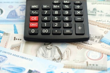 United Arab Emirates dirham currency money bills and calculator. The concept of taxation and money...