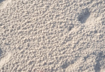 Close-up of naturally crystallized salt on the ground at the shore of a salt lake.