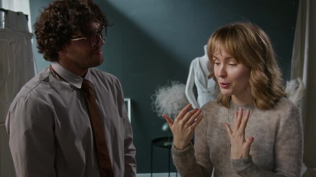 Two diverse young bridal shop consultants working with emotional woman, bringing her prefect wedding dress