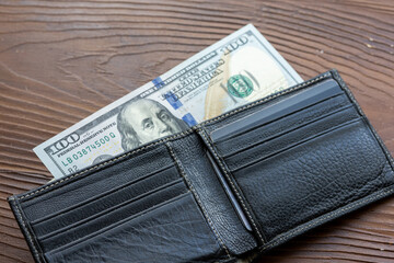 Cash in Black: US Dollars Tucked Inside a Leather Wallet