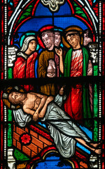 Stained glass (19th century) of The Way of the Cross. Fourteenth station: Jesus' body is placed in...