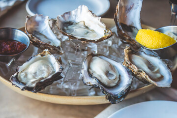 Oysters and Salmon on Trendy Ceramic Plate with Brown Paper Table Setting