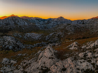 Majstorska road road at mountain Velebit in summer time in Croatia near croatia sea. Rocky peak of Tulove Grede at sunset