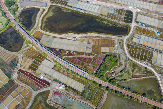 Aerial view of train passing through the salt marshes of Guerande, France