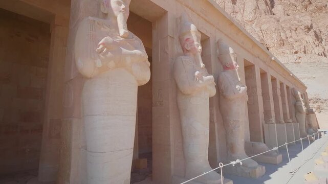Footage showcasing the majestic Mortuary Temple of Queen Hatshepsut, also known as Djeser Djeseru, nestled against the cliffs of Deir el Bahari on the West Bank of the Nile in Luxor, Egypt.