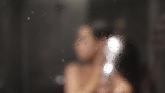 Relaxation and rest after a long stressful day. Young woman taking a shower.